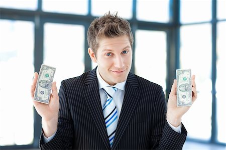 Young businessman holding dollars Stock Photo - Budget Royalty-Free & Subscription, Code: 400-04114551