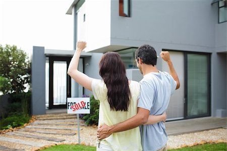 family with sold sign - Happy young couple after buying house Stock Photo - Budget Royalty-Free & Subscription, Code: 400-04114637