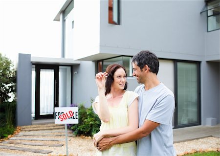 family with sold sign - Happy young couple after buying house Stock Photo - Budget Royalty-Free & Subscription, Code: 400-04114640