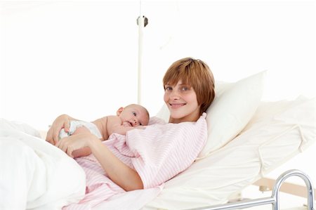 Mother embracing her newborn baby in the hospital Stock Photo - Budget Royalty-Free & Subscription, Code: 400-04114656