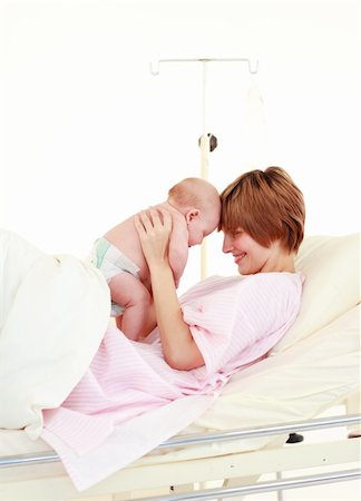 Mother embracing her newborn baby in hospital Stock Photo - Budget Royalty-Free & Subscription, Code: 400-04114670