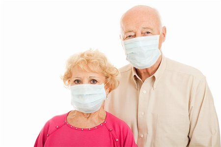 Worried senior couple wearing surgical masks to protect against an epidemic.  Isolated. Foto de stock - Super Valor sin royalties y Suscripción, Código: 400-04114746