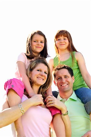simsearch:400-04115211,k - Portrait of happy family giving children shoulder rides Foto de stock - Super Valor sin royalties y Suscripción, Código: 400-04115209