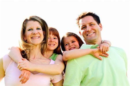 Portrait of happy family giving children piggy back rides Stock Photo - Budget Royalty-Free & Subscription, Code: 400-04115211