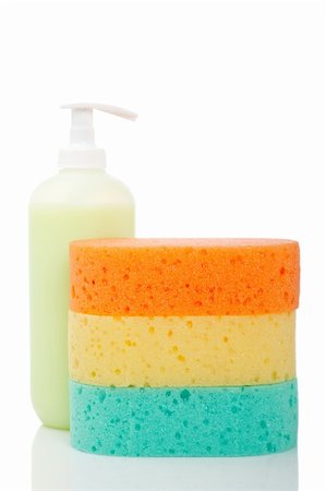 simsearch:400-04775286,k - Plastic pump soap bottle and sponges reflected on white background. Shallow depth of field Stock Photo - Budget Royalty-Free & Subscription, Code: 400-04116099