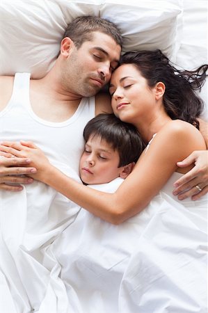 romantic pictures of lovers sleeping - Nice familiy sleeping together in a white bed Stock Photo - Budget Royalty-Free & Subscription, Code: 400-04116375