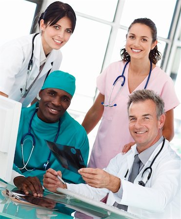 smiling industrial workers group photo - Group of doctors talking in an office about an X-ray Stock Photo - Budget Royalty-Free & Subscription, Code: 400-04116402