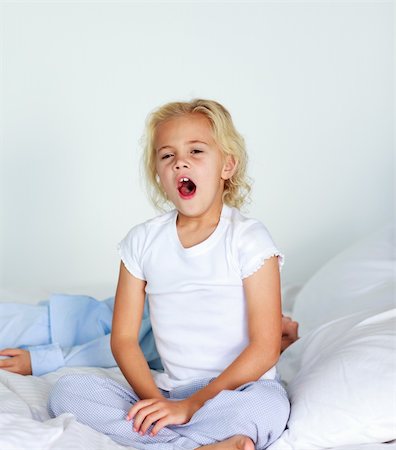 Beautiful daughter yawning in bed before sleeping Stock Photo - Budget Royalty-Free & Subscription, Code: 400-04116414