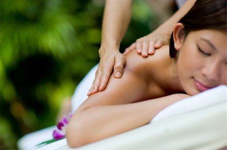 eastwestimaging (artist) - A woman getting a massage at a tropical spa Fotografie stock - Microstock e Abbonamento, Codice: 400-04116463