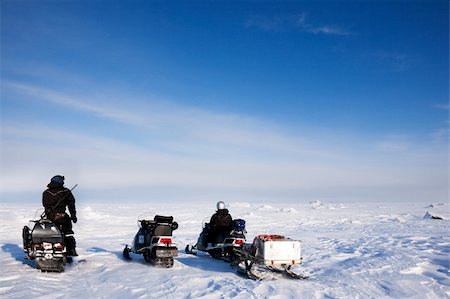 snowmobile man and woman - Three snowmobiles on a svalbard landscape of barren snow Stock Photo - Budget Royalty-Free & Subscription, Code: 400-04116615