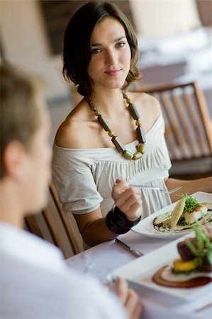 eastwestimaging (artist) - A young woman eating lunch at a restaurant Fotografie stock - Microstock e Abbonamento, Codice: 400-04116667