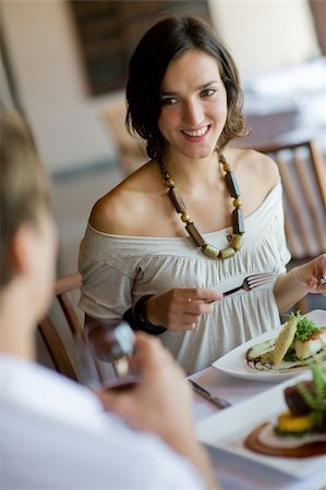 eastwestimaging (artist) - A young woman eating lunch at a restaurant Foto de stock - Super Valor sin royalties y Suscripción, Código: 400-04116668