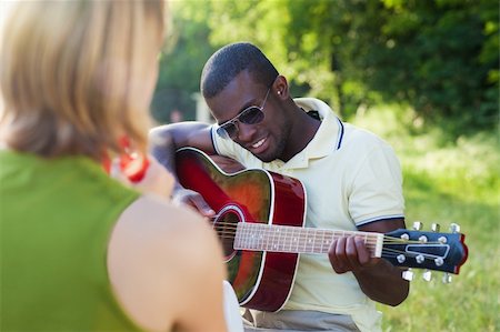 two friends playing guitar and tambourine outdoors Stock Photo - Budget Royalty-Free & Subscription, Code: 400-04116810