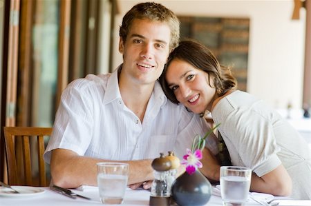 eastwestimaging (artist) - A young couple sitting together in a restaurant Fotografie stock - Microstock e Abbonamento, Codice: 400-04116900