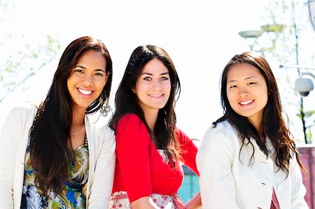 Group of three diverse young girlfriends smiling Stock Photo - Budget Royalty-Free & Subscription, Code: 400-04117740