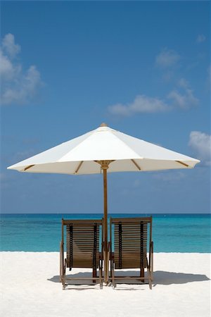 simsearch:400-08899199,k - Beach chairs and umbrella on a sand beach in Maldives Stock Photo - Budget Royalty-Free & Subscription, Code: 400-04117934