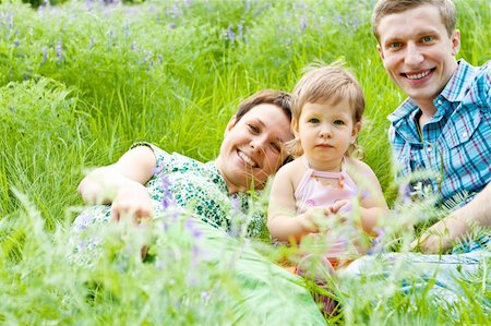 simsearch:400-07715953,k - Smiling parents and their daughter lying in the grass Stock Photo - Budget Royalty-Free & Subscription, Code: 400-04117948