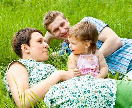 simsearch:400-06062677,k - Lovely family lying in the grass Photographie de stock - Aubaine LD & Abonnement, Code: 400-04117950