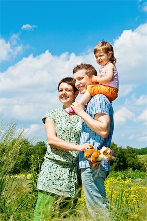 simsearch:400-07715953,k - Parents and their daughter standing in the meadow Stock Photo - Budget Royalty-Free & Subscription, Code: 400-04117951