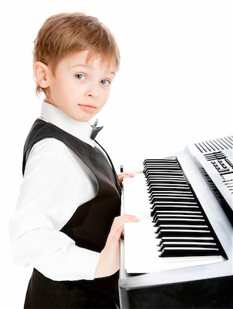 prodigio - Little prodigy pianist looking at the camera Fotografie stock - Microstock e Abbonamento, Codice: 400-04117953