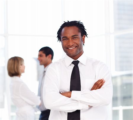 simsearch:400-07246047,k - Young African businessman with folded arms smiling at the camera Foto de stock - Super Valor sin royalties y Suscripción, Código: 400-04118271