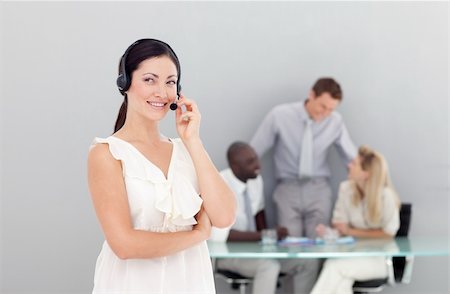 Beautiful young businesswoman with a headset on Stock Photo - Budget Royalty-Free & Subscription, Code: 400-04118319