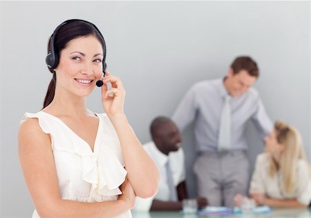 Attractive businesswoman talking on a headset in an office Stock Photo - Budget Royalty-Free & Subscription, Code: 400-04118320