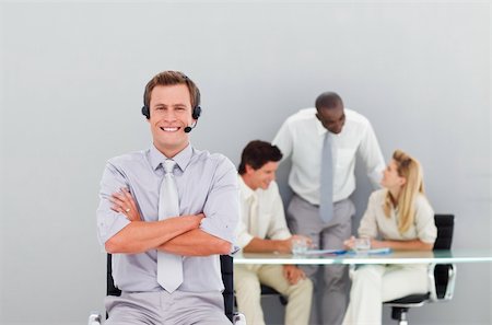 simsearch:400-04113098,k - Young and handsome businessman with a headset on in an office Stock Photo - Budget Royalty-Free & Subscription, Code: 400-04118322