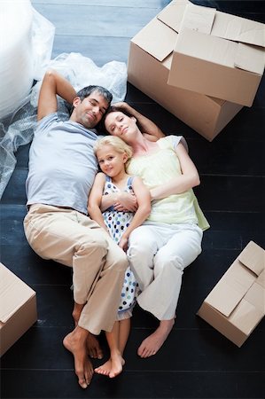 Parents and daughter lying on the floor of their new house Stock Photo - Budget Royalty-Free & Subscription, Code: 400-04118384