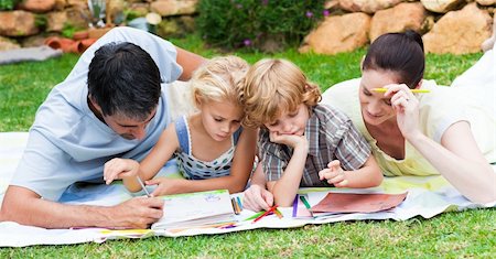 people reading books drawing - Happy family writing together in a park Stock Photo - Budget Royalty-Free & Subscription, Code: 400-04118418