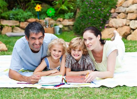 simsearch:400-06062677,k - Young smiling family relaxing together in park Photographie de stock - Aubaine LD & Abonnement, Code: 400-04118413