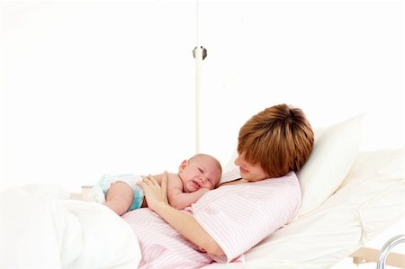 Patient speaking to her newborn baby in bed in hospital Stock Photo - Budget Royalty-Free & Subscription, Code: 400-04118440