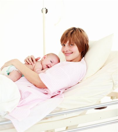 Patient with newborn baby in hospital smiling at the camera Stock Photo - Budget Royalty-Free & Subscription, Code: 400-04118466