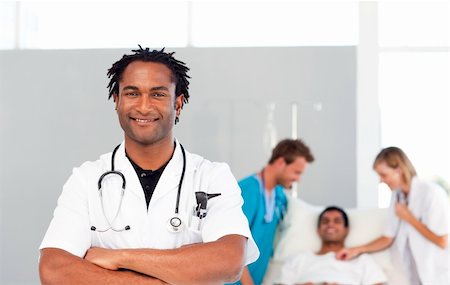 International doctors attending to a patient in  a hospital Stock Photo - Budget Royalty-Free & Subscription, Code: 400-04118486