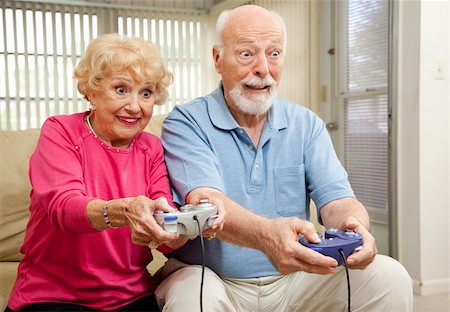 Senior couple having a great time playing video games. Stock Photo - Budget Royalty-Free & Subscription, Code: 400-04118530