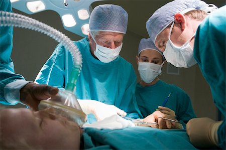 doctor in operation theater - Three Surgeons Operating On A Patient Stock Photo - Budget Royalty-Free & Subscription, Code: 400-04118995