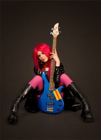 simsearch:400-05219431,k - Sexy rock girl with bass guitar, studio shot Fotografie stock - Microstock e Abbonamento, Codice: 400-04119059