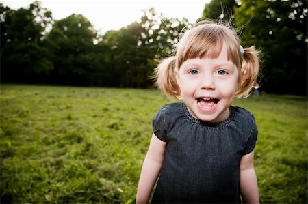 fun park mouth - Funny Girl On The Green Meadow Stock Photo - Budget Royalty-Free & Subscription, Code: 400-04119176