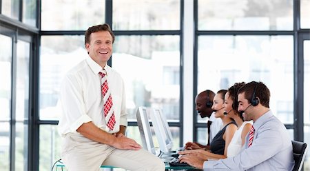 simsearch:400-04291703,k - Smiling senior manager working in a call center Stock Photo - Budget Royalty-Free & Subscription, Code: 400-04119309