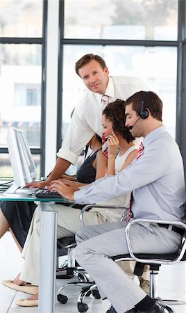 simsearch:400-04291703,k - Senior manager working in a call center looking at the camera Stock Photo - Budget Royalty-Free & Subscription, Code: 400-04119315