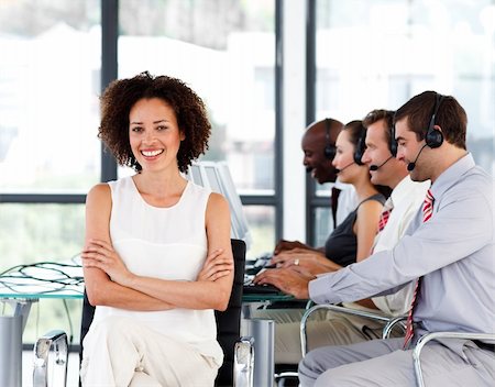 Smiling female manager working in a call center with her colleagues Stock Photo - Budget Royalty-Free & Subscription, Code: 400-04119327