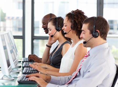 Young businesswoman working in a call center with his colleagues Stock Photo - Budget Royalty-Free & Subscription, Code: 400-04119328