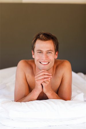 Smiling handsome young boy lying in bed with copy-space Stock Photo - Budget Royalty-Free & Subscription, Code: 400-04119362