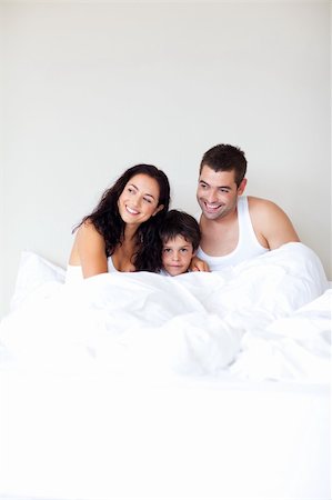 simsearch:400-04196942,k - Happy family playing with his son in bed with copy-space Photographie de stock - Aubaine LD & Abonnement, Code: 400-04119370