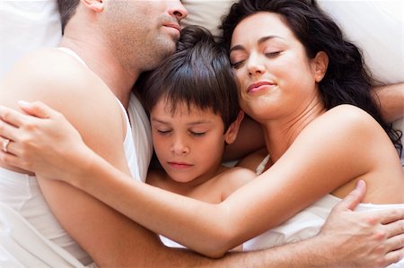 Portrait of a young family sleeping in bed Stock Photo - Budget Royalty-Free & Subscription, Code: 400-04119380