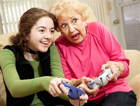 simsearch:400-04300757,k - Grandmother and granddaughter playing an exciting video game together. Photographie de stock - Aubaine LD & Abonnement, Code: 400-04119582