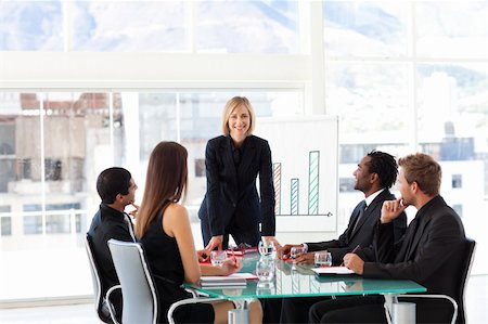 simsearch:400-06567931,k - Attractive female manager smiling at the camera in a meeting Stock Photo - Budget Royalty-Free & Subscription, Code: 400-04119644