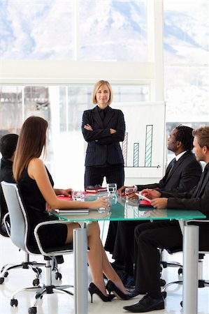 simsearch:400-06567931,k - Serious businesswoman looking at the camera in a presentation Stock Photo - Budget Royalty-Free & Subscription, Code: 400-04119645