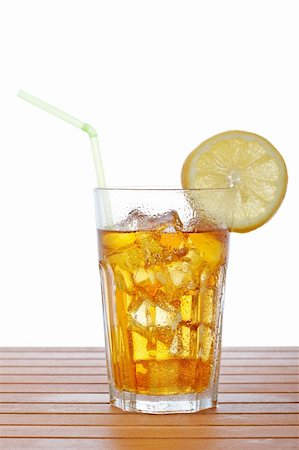 A glass of ice tea with lemon slice and straw on wooden background. Shallow depth of field Stock Photo - Budget Royalty-Free & Subscription, Code: 400-04119725