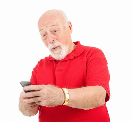 Senior man receives a surprising text message on his cellphone.  Isolated. Stock Photo - Budget Royalty-Free & Subscription, Code: 400-04119818